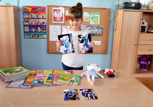 Zuzia prezentuje kolekcję książek, maskotek i zdjęć z Kicią Kocią.